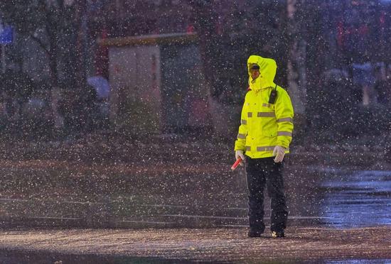 On the evening of January 26th, Changsha. The traffic police are on duty in the snow. Reporter Jun Tang photo